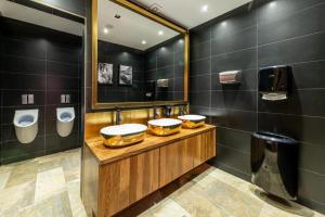 a bathroom with two sinks and two urinals at Hotel Aleksandar Rafailovići in Budva +67 photos