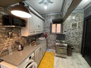 a small kitchen with a sink and a stove at Dora home in Cairo