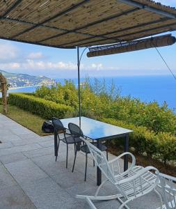 a table and chairs sitting under an umbrella at VILLA AGA in Noli