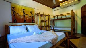 a bedroom with a bed and two bunk beds at Kays Place Train house Jambo in Zanzibar City
