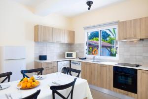 a kitchen with a table and chairs and a window at Sun Beach Villa Thio in Polis Chrysochous