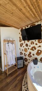 a bathroom with a tub and a tv on a wall at Dajti Alpin Villas in Tirana