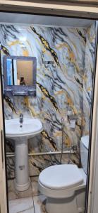 a bathroom with a sink and a toilet at Khinalig Shaiq Guest House in Xınalıq +23 photos
