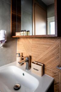 a bathroom with a white sink and a mirror at Vento di Mare in Perea