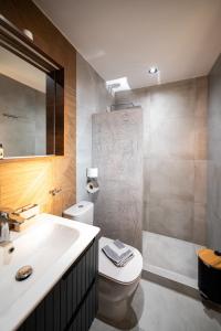 a bathroom with a sink and a toilet and a shower at Vento di Mare in Perea +48 photos