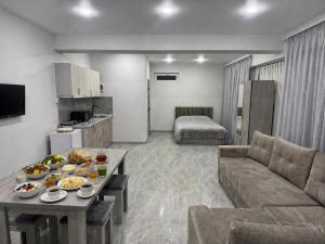 a living room with a couch and a table with food on it at Manes in Yeghegnadzor +8 photos