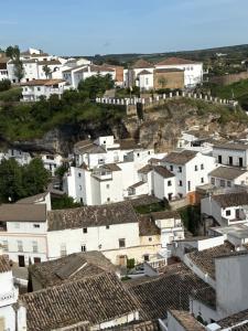 a village with white houses on a hill at Casa del Abuelo in Setenil