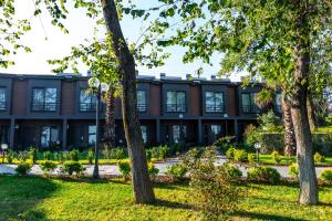 an office building with trees in front of it at Santana Resort Otel in Trabzon