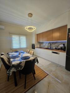 a kitchen with a table and chairs and a kitchen with a kitchen at Villa Ndoni in Berat