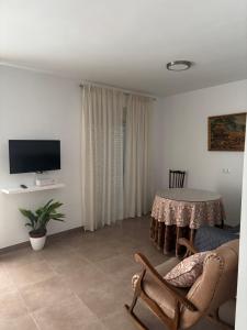 a living room with a table and a chair at Casa del Abuelo in Setenil