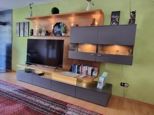 a living room with a large entertainment center with a flat screen tv at Zum Blauglockenbaum in Zell an der Mosel