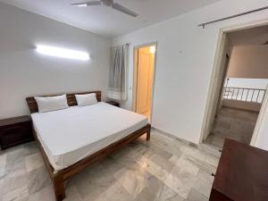 a bedroom with a white bed in a room at Giostay Residency in New Delhi