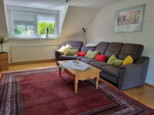 a living room with a couch and a table at Zum Blauglockenbaum in Zell an der Mosel +20 photos