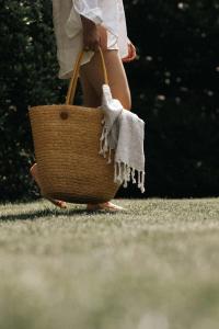 a woman holding a wicker basket with her feet at SIEGI apartments & retreat - Merano Südtirol in Parcines