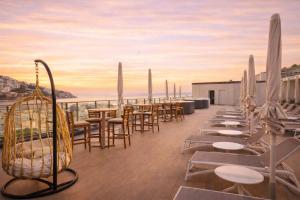 a row of tables and chairs on a roof at Palladium Hotel Peñiscola in Peniscola
