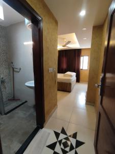 a room with a door open to a bedroom with a bed at Aqaba Roza in Aqaba +101 photos