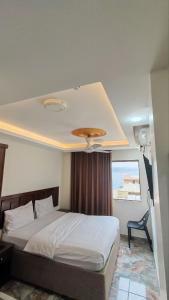 a bedroom with a bed with a ceiling at Aqaba Roza in Aqaba