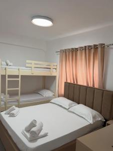 a bedroom with a bed and bunk beds in it at Aurea Rooms in Vlorë