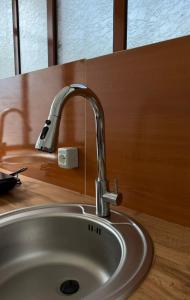a bathroom sink with a faucet on a counter at Aurea Rooms in Vlorë +28 photos