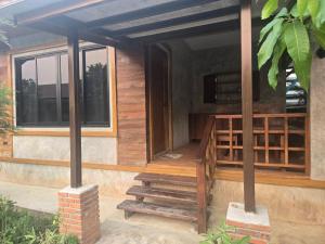 a small house with a porch and a staircase at Cocoa Hut in Mae Chan