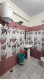 a bathroom with a pink bird mural on the wall at RK Residency Hotel & Resturant in Ukhimath +35 photos