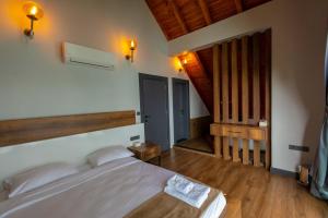 a bedroom with a bed and a wooden floor at Santana Resort Otel in Trabzon