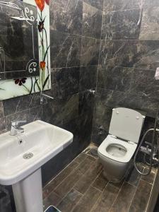 a bathroom with a toilet and a sink at Kimka in Aswan