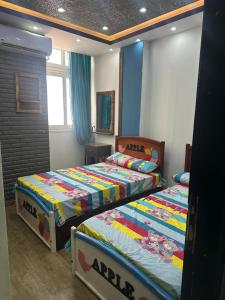 a bedroom with two beds in a room at Kimka in Aswan