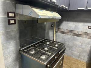 a kitchen with a stove top in a room at Kimka in Aswan