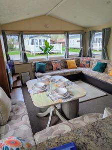 a living room with a table and a couch at 26 The Meadows in Tattershall