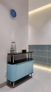 a clock on a wall above a blue cabinet at Mik Stay 2 in Danang +32 photos