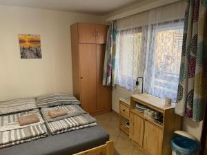 a small bedroom with a bed and a desk at Chatky U Davida Máchovo jezero in Staré Splavy