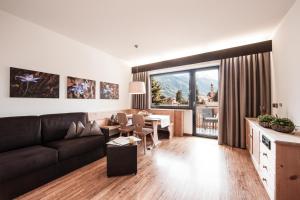 a living room with a couch and a table at SIEGI apartments & retreat - Merano Südtirol in Parcines