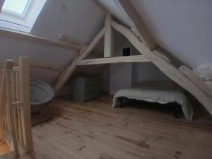 a room with a bunk bed in a attic at Chambres d'hôtes in Annoisin-Chatelans
