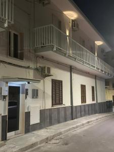 a building with a balcony on the side of it at Giocca Rooms in Palagiano