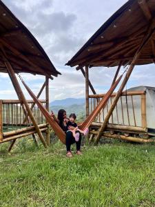 a woman and a child sitting on a slide at Conexión naturaleza in San Luis +13 photos
