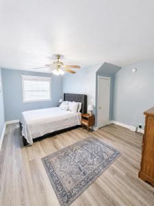 a bedroom with a bed and a ceiling fan at Peach Door Cottage in Lufkin