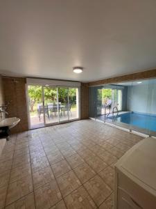 a large room with a swimming pool and a sink at Villa avec piscine intérieure, proche Strasbourg in Holtzheim +33 photos
