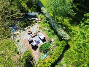 an overhead view of a backyard with a pool and a house at Les champs sauvages in Saint-Barnabé