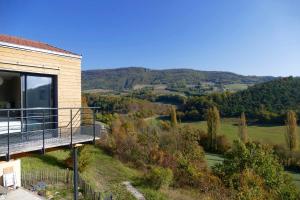 a balcony of a house with a view of the countryside at Villa d'architecte avec vue imprenable in Cobonne