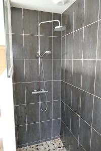 a shower with a shower head in a bathroom at Villa d'architecte avec vue imprenable in Cobonne +15 photos