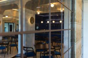 a view of a restaurant with tables and chairs at Hotel Apolodor in Orşova +17 photos
