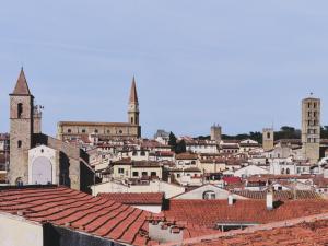 a view of a city with roofs and a church at Hotel I Portici in Arezzo
