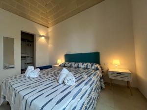 a bedroom with a bed with two pillows on it at Le Muciare in Favignana