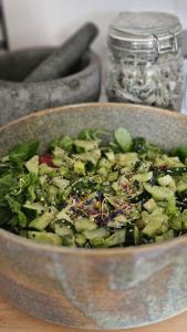 a salad in a bowl on a table at Les champs sauvages in Saint-Barnabé