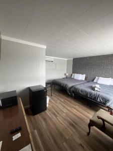 a bedroom with two beds in a room at Gateway Motel USA in Madawaska