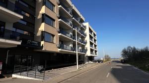 an empty street in front of a building at TheBlueEscape Apartment in Năvodari