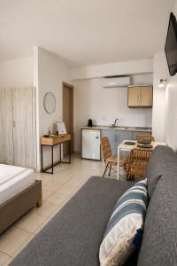 a living room with a couch and a table and a kitchen at Filoxenia in Platy