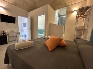 a bedroom with a large bed with two pillows on it at Le Muciare in Favignana