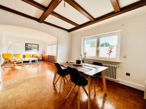a living room with a table and chairs at 3 sonnige Appartements in Soltau in Soltau